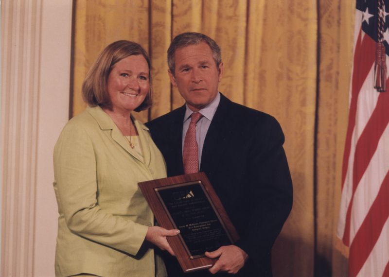 Cindy McEntee, owner of Mo's Restaurants, receives SBA Small Business of the Year 2001 1st runner up award from President George W. Bush.